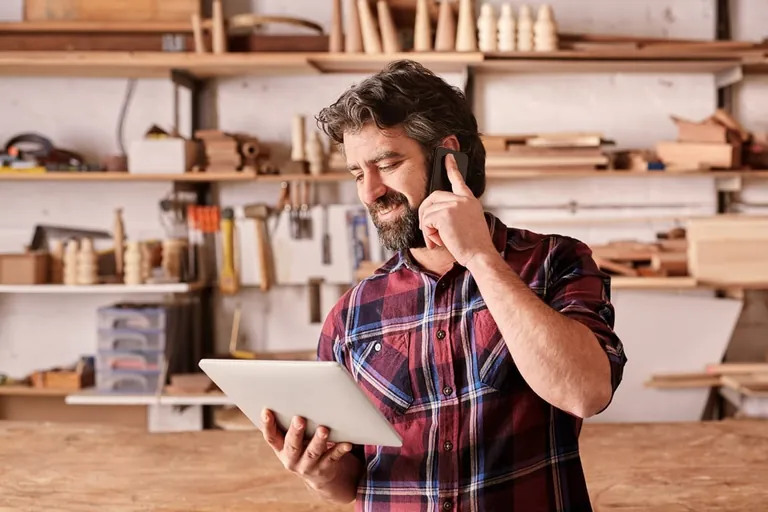 Handwerker telefoniert, Smartphone, Tablet